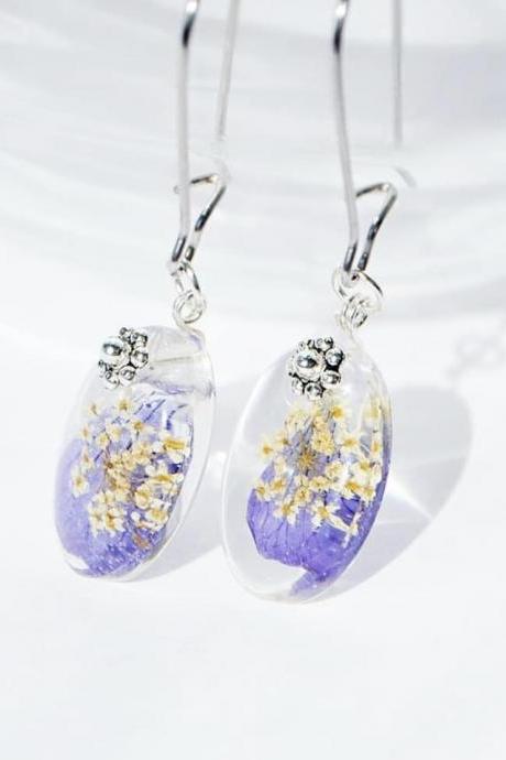 Baby ovals with a meadow geranium petal and anise umbrellas dangle resin earrings